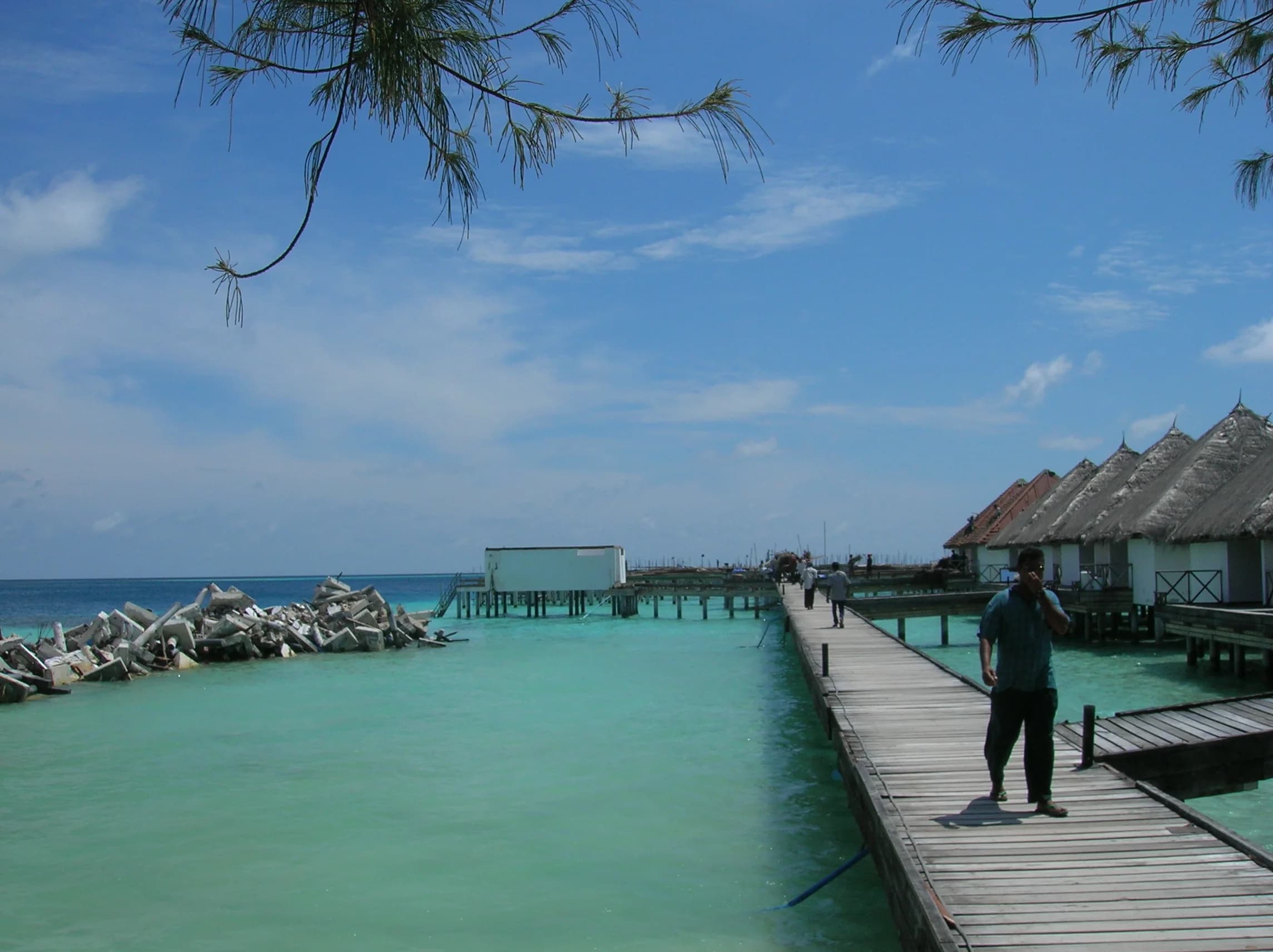 Rock revetment protecting a resort shoreline with water villas beyond